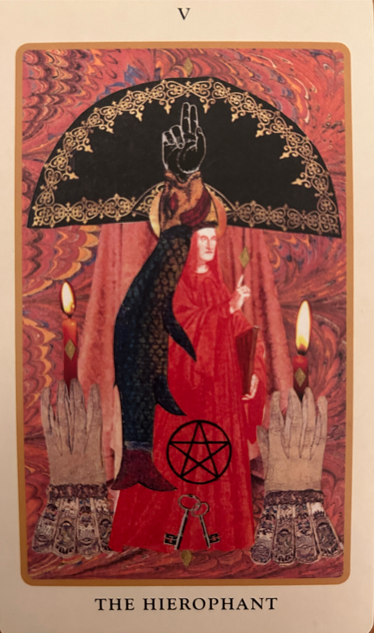 a tarot card showing two hands holding candles and a red-robed priest figure in the center