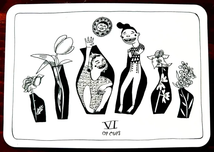 6 of Cups tarot card showing 6 black silhouette vases in which flowers and children are peeking out, a sun with a face hovers above