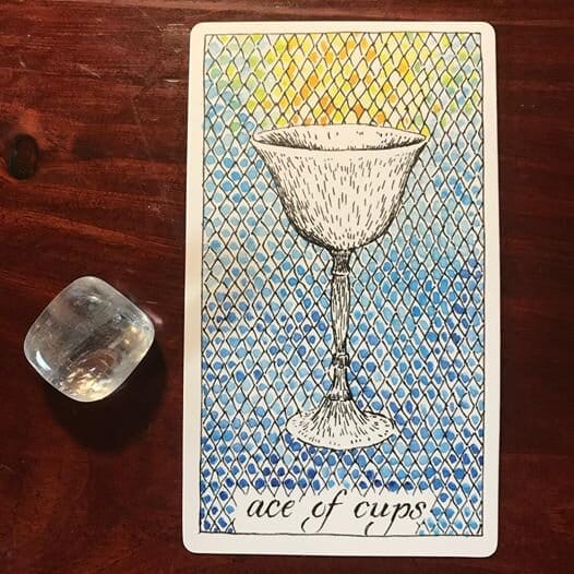 a line drawing of a white long-stemmed goblet against a blue and yellow snakeskin background