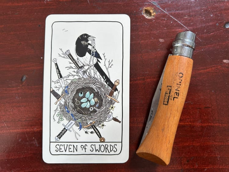 a bird with a beaded necklace in its beak perches on the edge of a nest with blue eggs and trinkets and knives sticking out of it