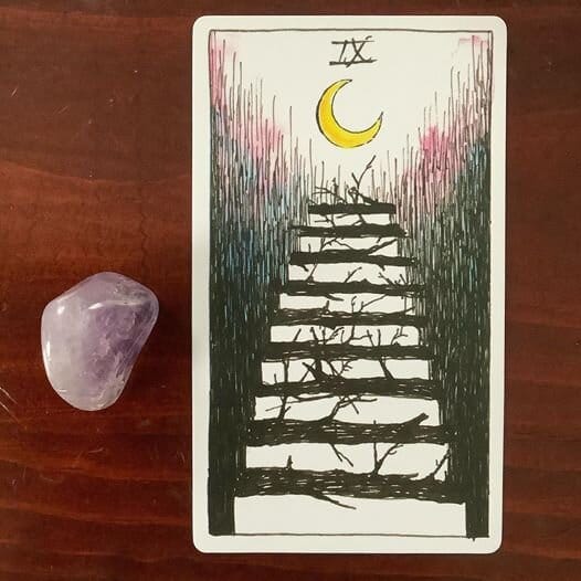 a staircase made of rustic branchy logs that leads up to a yellow balsamic crescent moon