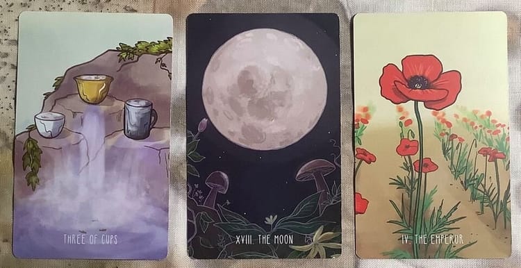 3 tarot cards against an ecoprinted textile