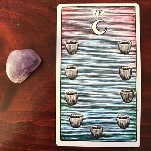 9 small black cups form the shape of a single larger cup against a pink-to-blue ombre background with horizontal lines and a white balsamic crescent moon